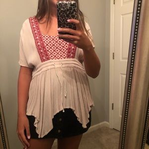 boho cream top with string tie and red embroidery